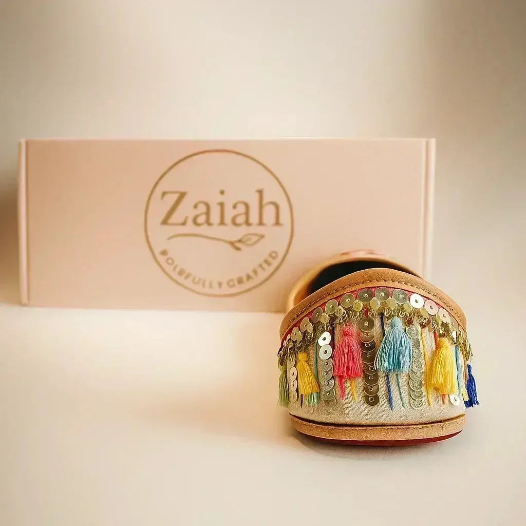 Handcrafted jutti with colorful tassels and sequins, perfect for festive or romantic styles.