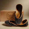 Black embellished juttis with crystal details, handcrafted flat shoes for elegant occasions