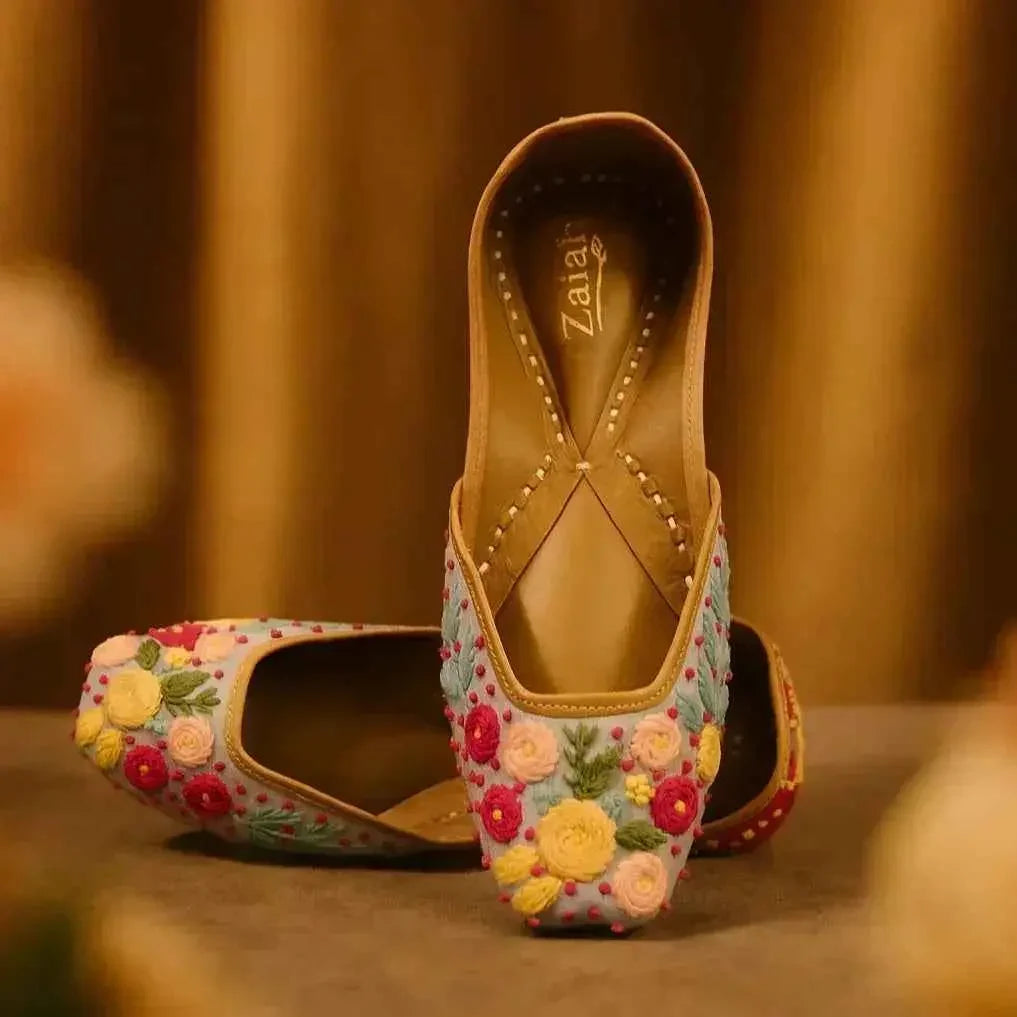 Handcrafted floral embroidered juttis with vibrant roses, perfect for romantic styles and seasonal elegance.
