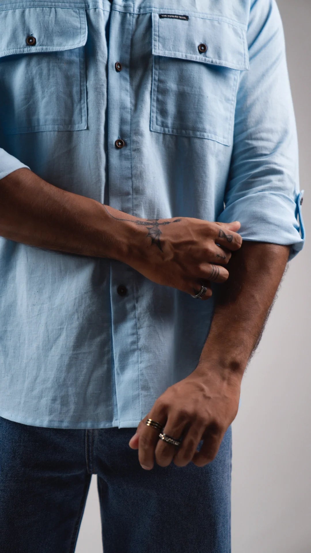 male model rolling sleeve closeup