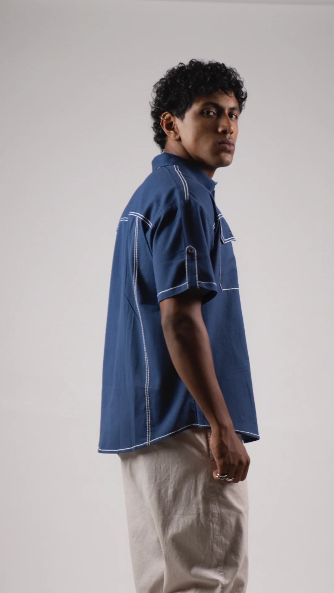 Side view of a man wearing a blue cotton linen half-sleeved shirt
