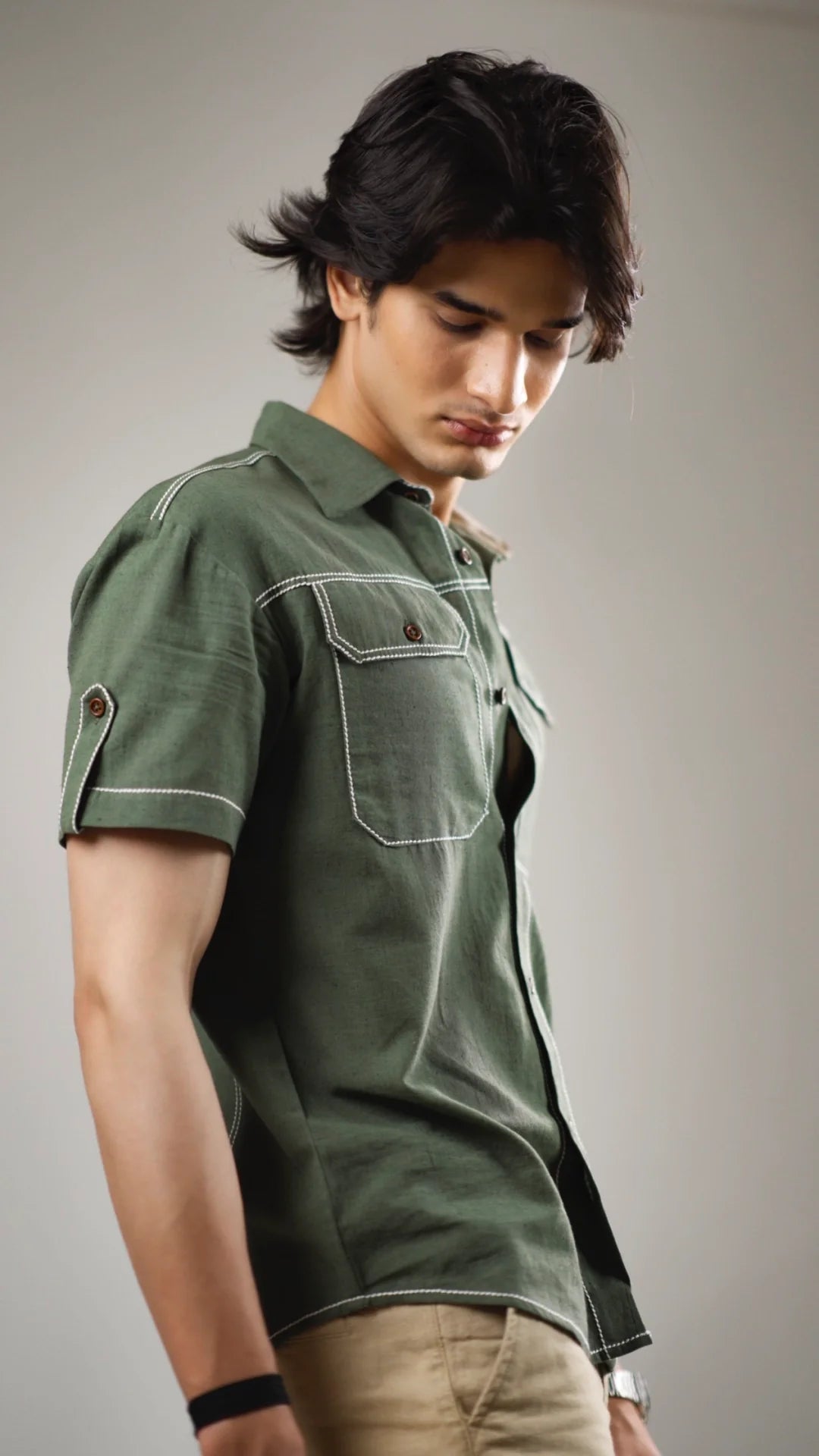 Man wearing a fern green cotton linen shirt with a neutral background